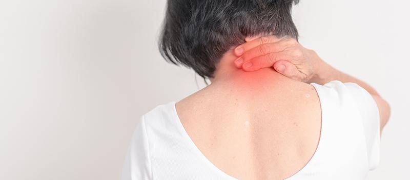 Woman experiencing neck discomfort from cervical spinal stenosis.