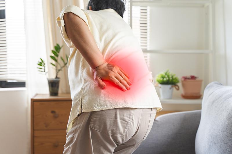 Older woman feeling back pain at home
