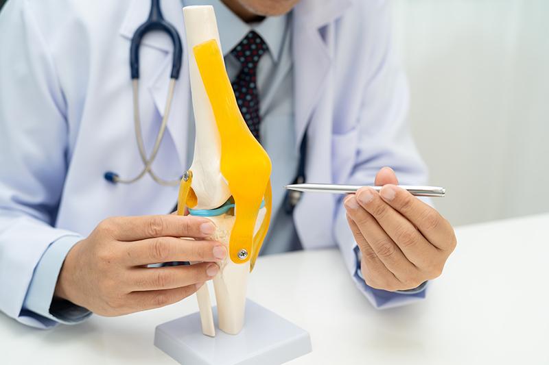 Spine surgeon discussing treatment options for lumbar spinal stenosis with a patient during a consultation.