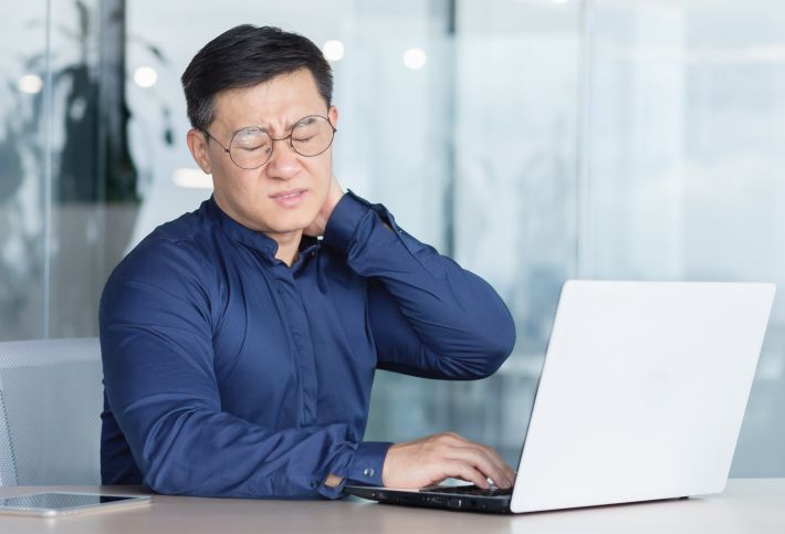 Man suffering from neck pain