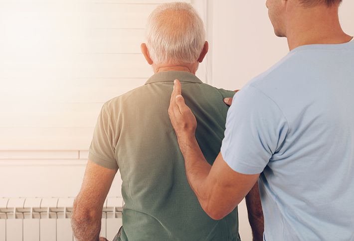 Doctor diagnosing patient with spinal stenosis.