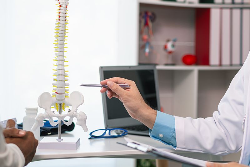 A patient consulting a specialist for a spine problem