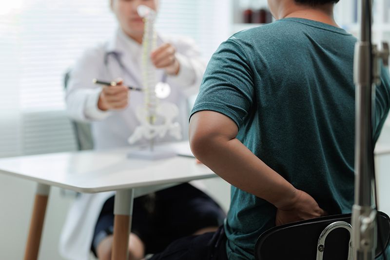 A patient suffering from back pain consulting a specialist