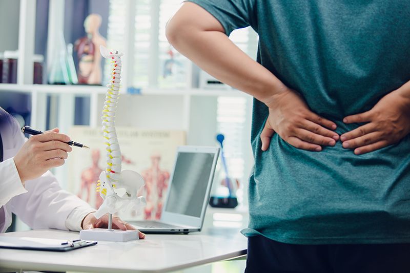 A patient consulting a specialist for back pain